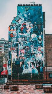 a large mural on the side of a building at WelcomeStay Fitzrovia Two Bed Apartments - Sleep in Opulent Luxury in London
