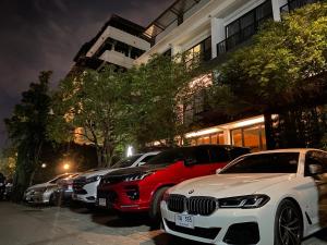 a row of cars parked in a parking lot at Azz Hotel in Chiang Mai