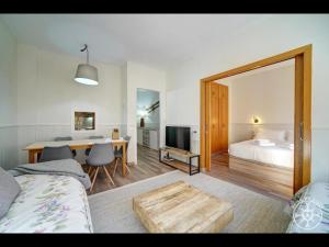 a bedroom with a bed and a dining room with a table at MALADETA de Alma de Nieve in Baqueira-Beret