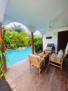 a living room with a view of a swimming pool at NEW HOUSE TROPIC PARADISE with Pool in Willemstad