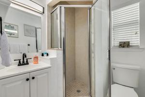 a bathroom with a shower and a toilet and a sink at Enjoy the Pool while being Steps from Beach and Restaurants! - Coconut Villa's Suite 6 in St. Pete Beach