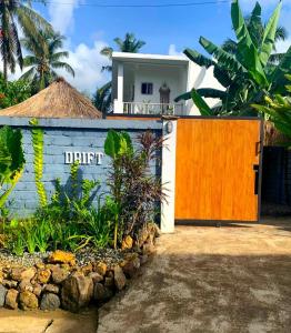 a gate to a house with a sign that reads drift at Drift Hideaway in Kuta Lombok