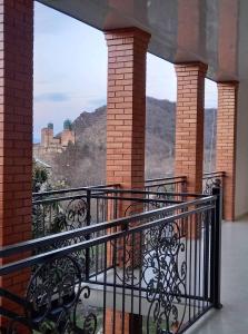 a balcony with a view of the view of the castle at Family hotel leni in Kvareli