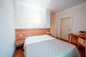 Postel nebo postele na pokoji v ubytování Garnì Vecchio Comune