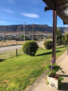 a porch with a flower pot and a road at HOSPEDAR CALAFATE - Los Lupinos in El Calafate