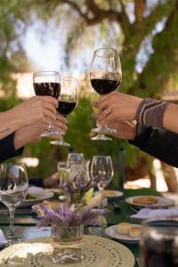a group of people holding up wine glasses on a table at Hacienda de Molinos Hotel in Molinos