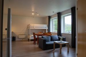 a living room with a couch and a table at Vollvaagen Apartments Smøla, boat included in Smøla
