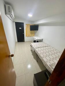 um pequeno quarto com uma cama e uma mesa em La Casona 42 em Barranquilla
