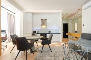 a living room with a table and chairs at 16141 Jack House Panoramic city view in Kyiv