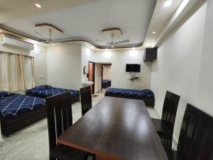 a dining room with a table and chairs in a room at Lavish 2BHK, 10 mins from AMRI Hospital Dhakuria in Kolkata