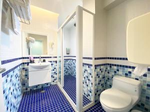 a bathroom with a toilet and a sink at 伊莎愛莉溜滑梯親子民宿 in Wujie