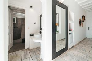 a bathroom with a sink and a mirror at Mr & Mrs White Mykonos in Platis Gialos