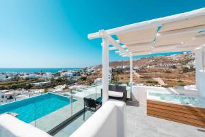 a villa with a swimming pool and a view at Mr & Mrs White Mykonos in Platis Gialos