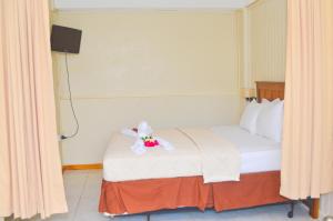Ein Bett oder Betten in einem Zimmer der Unterkunft Classique International in Dominica
