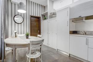 a kitchen with a table and a clock on the wall at CAPO D'AFRICA 30 - COLOSSEO in Rome
