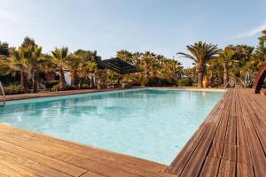 a large swimming pool with a wooden deck at Relax in Vieste
