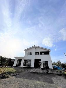 a white house with a lot of windows at HIROSAKI清水森はうす in Hirosaki