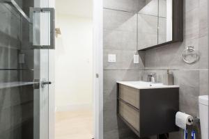 y baño con lavabo y espejo. en 75-1C New 1BR prime UES W D the unit Best Value, en Nueva York