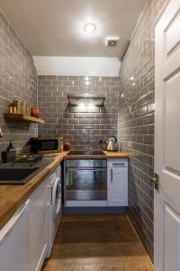 a kitchen with a washer and dryer in it at ALTIDO Contemporary cottage with parking in Edinburgh