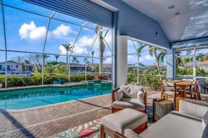 a view of the pool from the living room of a house at Marco Paradise in Marco Island