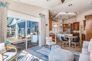 a kitchen and living room with a table and chairs at Marco Paradise in Marco Island