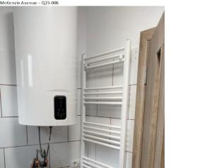 a kitchen with a white cupboard with a phone on it at Pridvorul lui Viorel in Proviţa de Sus