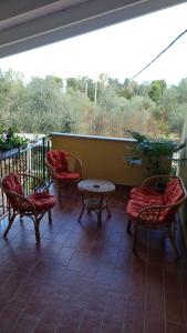 a porch with chairs and a table on a balcony at B&B Verdeoliva in Modugno