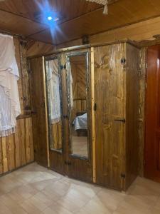 a room with wooden walls and a room with a mirror at Гостинний Двір Вишня in Bukovel