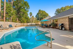 a swimming pool in the backyard of a house at Outdoor Oasis by Beaches in Gulf Breeze