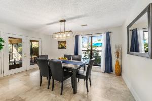 a dining room with a table and chairs at Outdoor Oasis by Beaches in Gulf Breeze