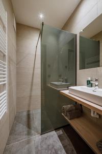 a bathroom with a sink and a glass shower at Schafalm Dahoam in Schladming