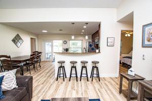 a living room and kitchen with a couch and a table at Heather Lakes Retreat in Brandon