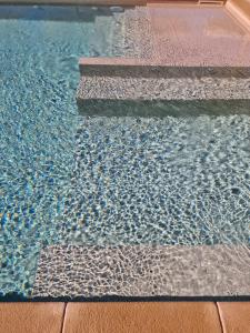 a pool of water with some rocks in it at Tenuta Santa Caterina in Portoferraio