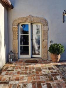 an open door to a house with a potted plant at Tenuta Santa Caterina in Portoferraio