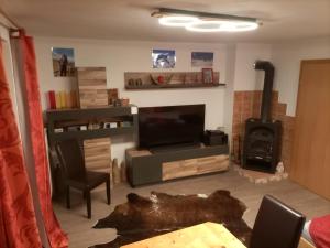 A television and/or entertainment centre at Ferienwohnung Felix-Adults Only