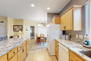 a kitchen with a refrigerator and a dining room at Sittin' By The Sea in Pacific City