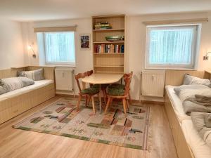 a living room with a table and chairs and a couch at Ferienwohnung "Am Waldrand" in Sankt Peter-Ording
