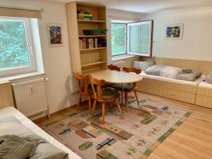 a living room with a table and chairs and a bed at Ferienwohnung "Am Waldrand" in Sankt Peter-Ording