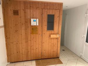 a wooden door in a room with a wall at Westbrise App 7 in Wenningstedt