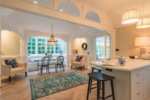 a kitchen and living room with a table and chairs at Victory at Cliffe in Kingsdown