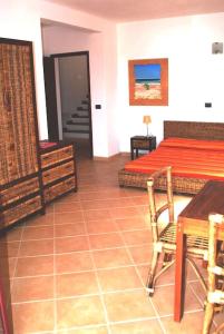 a bedroom with a bed and a table and chairs at Oleandro Ocean Apartment in Santa Maria