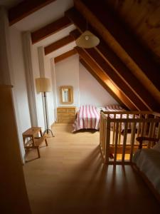 a attic room with a bed and a lamp at Duplex Sky, muy cerca estación ski, Bonito y acogedor in Pla de l'Ermita