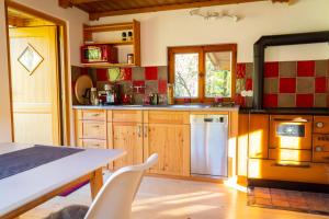 a kitchen with wooden cabinets and a counter top at Alpenchalet Sachrang in Sachrang