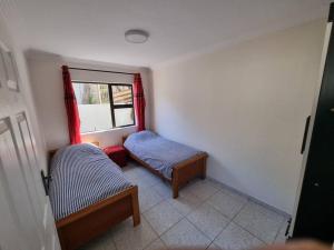 a small room with two beds and a window at A Gem in Clansthal in Clansthal +12 photos