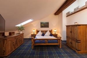 a large bedroom with a bed and a tv at Vitusfort Doppelzimmer Loch Ness in Füssen