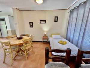 a room with a bed and a table and chairs at Bushbabies-Inn Self-Catering Accommodation in Swakopmund