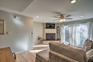 a living room with a couch and a fireplace at Lovely Iowa City Townhome about 3 Mi to Dtwn! in Iowa City