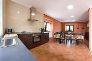 a kitchen with a table and a dining room at Villa Paula in Avilés