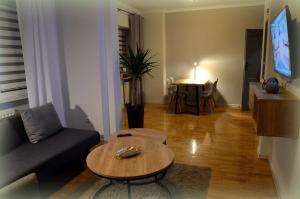 a living room with a couch and a table at Apartament Gwiazda 303 in Krynica Zdrój