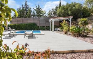 a patio with a pool and a pergola at 3 Bedroom Cozy Home In Caunes Minervois in Caunes-Minervois